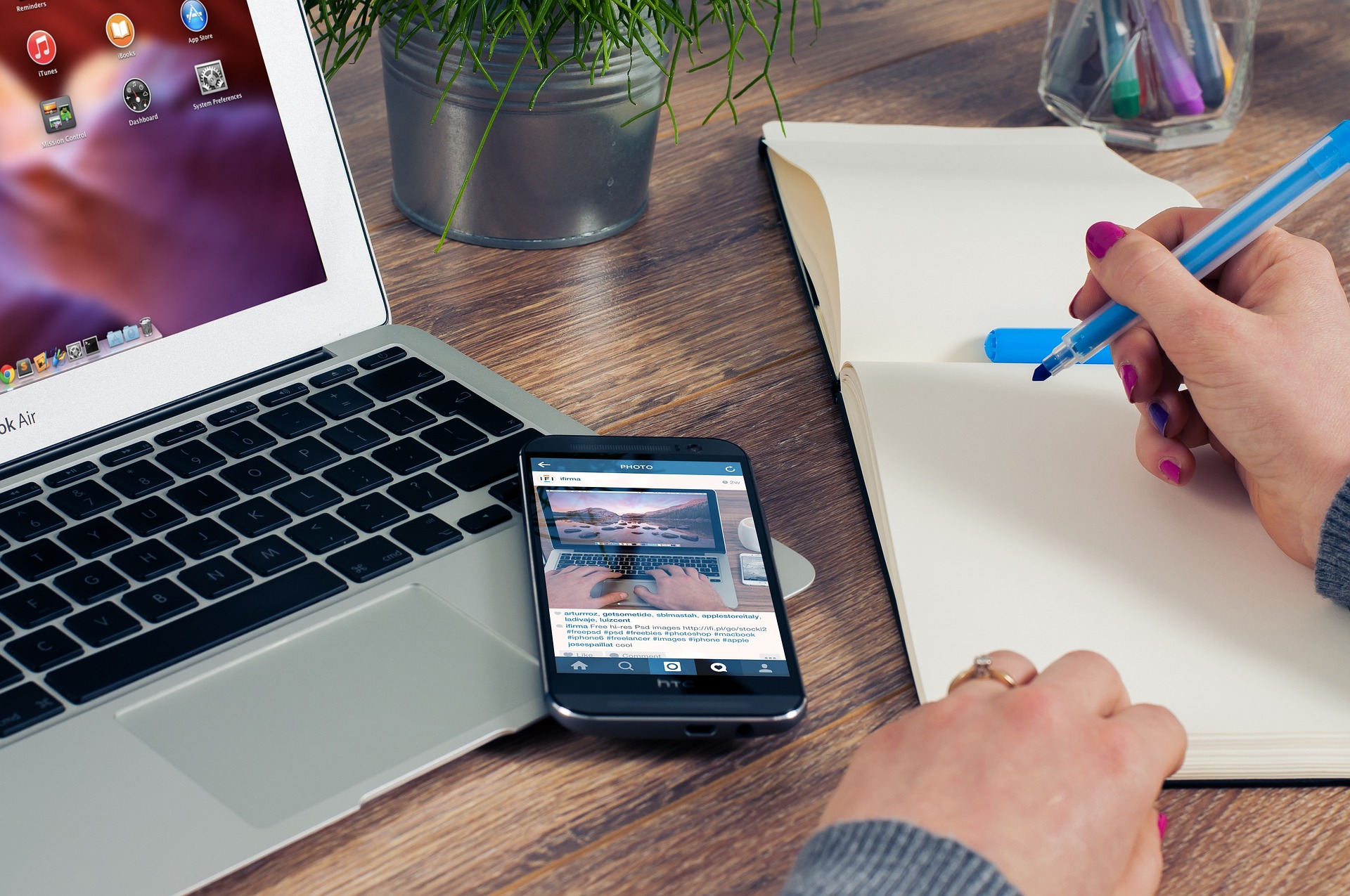 Laptop, mobile phone and notepad with hand writing